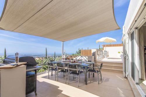 a patio with a table and chairs on a balcony at Villa Vista by Algarve Holidays in Valados