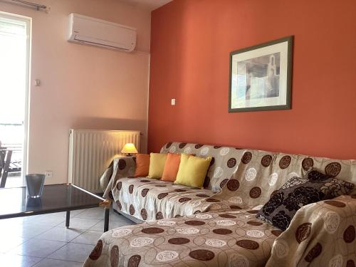 a living room with a couch and a table at Soft Horizon Apartment in Loutraki