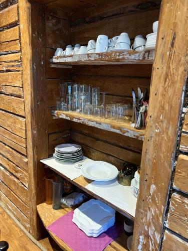 a shelf with plates and cups and dishes on it at Rüütli kodumajutus in Paide