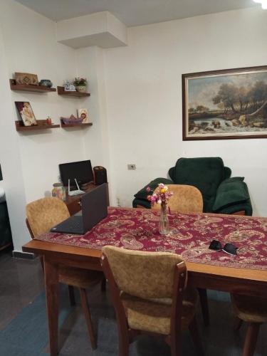 a living room with a table with a laptop on it at Moon e Sky in Tirana