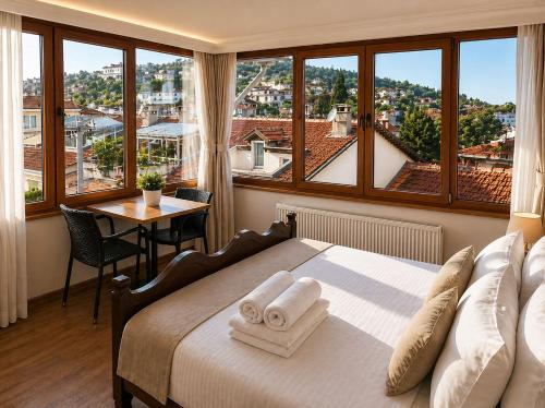 a bedroom with a bed and a view of a city at Selanikli Hotel Heybeliada in Istanbul