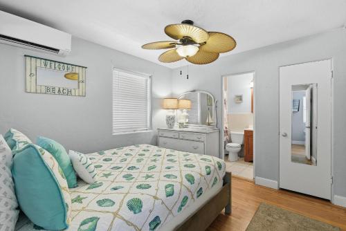 a bedroom with a bed and a ceiling fan at Flagler Suites 3 in New Smyrna Beach