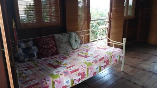 a small bed in a room with a window at Villa Diantie in Bogor