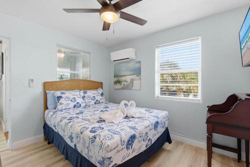 a bedroom with a bed and a ceiling fan at Flagler Suites 2 in New Smyrna Beach
