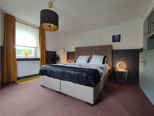 a bedroom with a large bed and a window at The Ardennes Apartment in Houschthauser