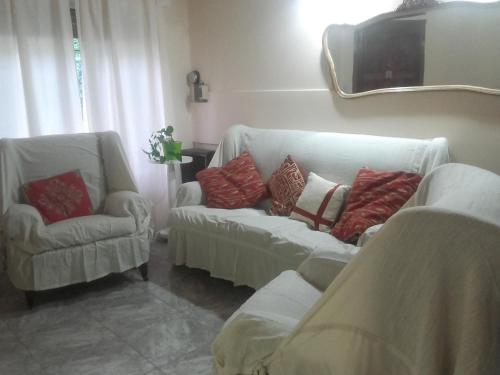 a living room with two couches and a tv at Las Acacias De Santa Rosa in Santa Rosa