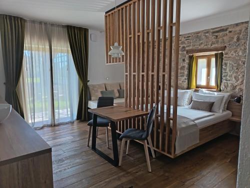 a bedroom with a bed and a table with chairs at PIRA BOUTIQUE hotel in Postojna