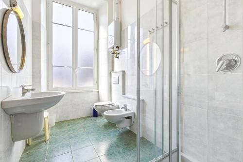 a white bathroom with a sink and a toilet at Hostdomus - Villa Emma - Zoe e Ascanio in Alassio