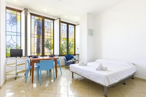 a bedroom with a bed and a desk with a computer at Hostdomus - Villa Emma - Zoe e Ascanio in Alassio