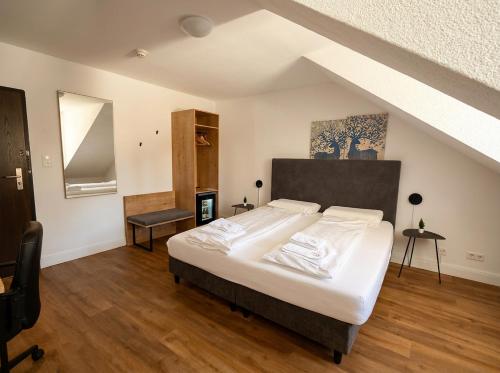 a bedroom with a large bed in a attic at Hotel Hechtplatz Self Check In in Zurich