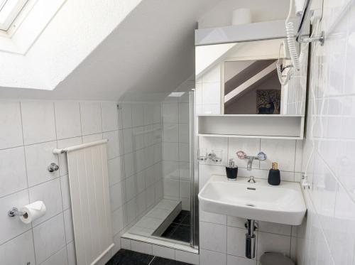 a white bathroom with a sink and a shower at Hotel Hechtplatz Self Check In in Zurich