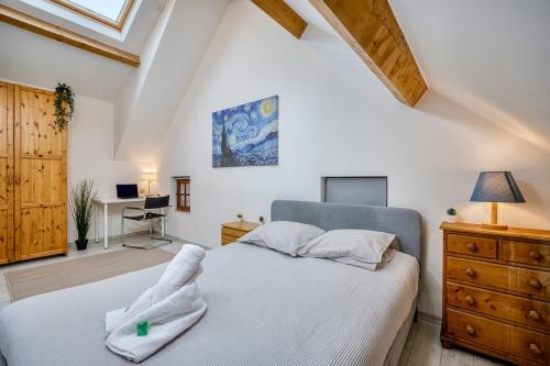 a bedroom with a white bed and a desk at COLIVING - Private Suite Bathroom - Toilet in Saint-Jean-de-Gonville