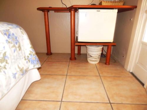a table sitting on top of a tiled floor with a table at Apartamentos Sulla Collina Centro de Gramado localizado próximo da rua Coberta in Gramado