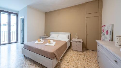 a bedroom with a bed with two towels on it at La Casa Di Nicole by Rentbeat in Polignano a Mare