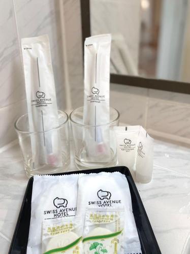 a table with two containers of soap and towels at SWISS AVENUE HOTEL in Sungai Petani