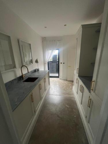a kitchen with a sink and a counter top at 4 Bayswater in New Brighton
