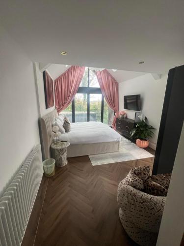 a bedroom with a bed and a large window at 4 Bayswater in New Brighton