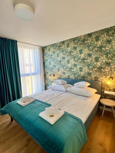 a bedroom with a large bed with towels on it at AMuSE ME in Kielce