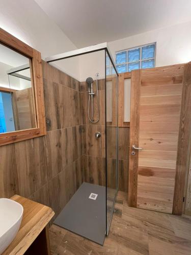 a bathroom with a shower with a glass door at Seandre Holiday Apartments in Prada