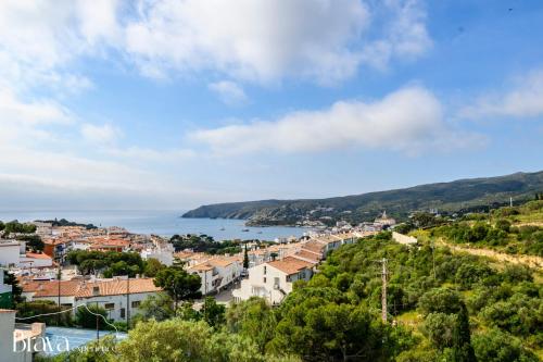 a view of a town on a hill with a body of water at Can Rino - Vistas panorámicas I piscina I tenis I terraza I Brava Experience in Cadaqués