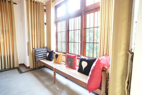 a room with a bench in front of a window at Muthu Villa, Kandy in Nikawatawana