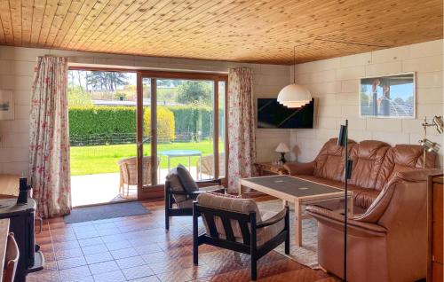 a living room with a couch and a table at Stunning Home In Hundested With Wifi in Hundested