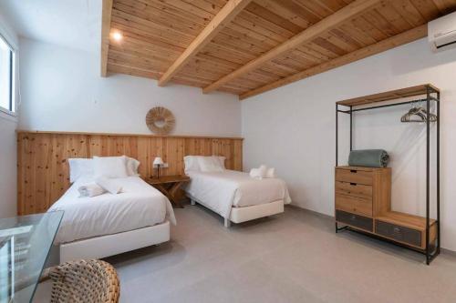 a bedroom with two beds and a mirror at Naramia Sagaro Villa - with Pool-garden-10 Pax in S'agaro