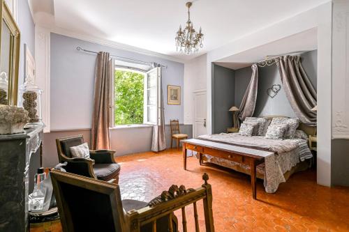 a bedroom with a bed and a window at Château De Jouques in Gémenos