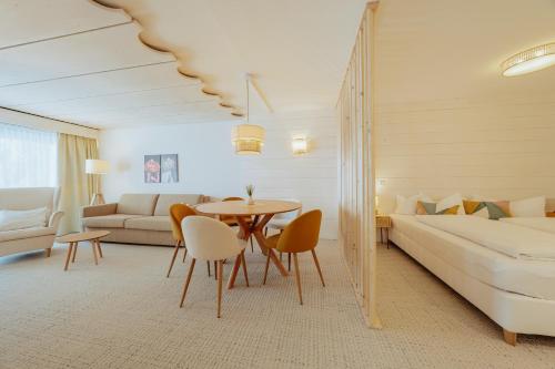 a hotel room with a bed and a table and chairs at Apartment Hotel Pfeifer in Gaschurn