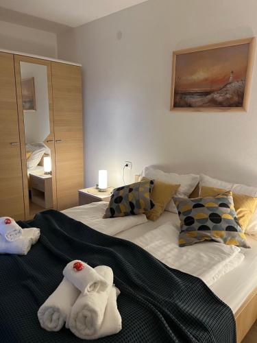 a bedroom with a bed with towels on it at V Apartment in Rabac