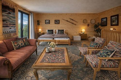 a living room with a bed and a couch at Nastawka Cottage Creativity and Regeneration in Raciechowice