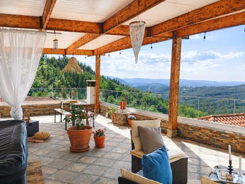 an outdoor patio with a view of the mountains at A Encantada Spa e Vista 180 Casa de Artista in Alqueve