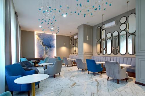 a waiting room with tables and chairs and balloons at Harvey Spa Hotel in Františkovy Lázně