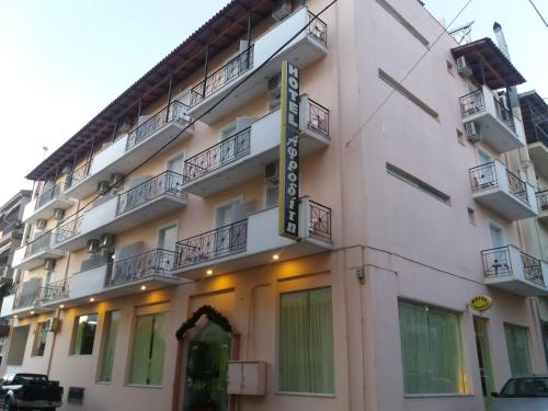 a building with a sign on the side of it at Ξενοδοχείο Αφροδίτη- Hotel Aphrodite in Nafpaktos