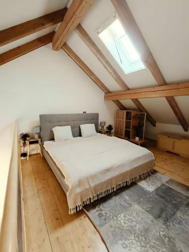 a bedroom with a large bed in a attic at Südsteirer Suite in Bad Radkersburg