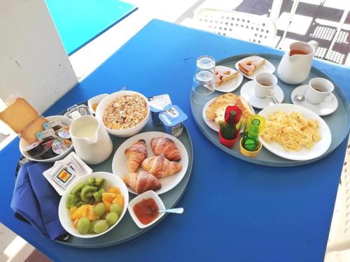 a blue table with plates of food on it at BorgoMarino's Room in Cefalù