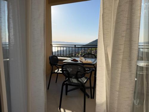 a balcony with a table and chairs and a view at Holiday Home Nada in Tučepi