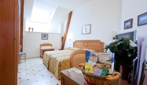 a bedroom with a bed and a table with books at Villa Angelina in Massa Lubrense