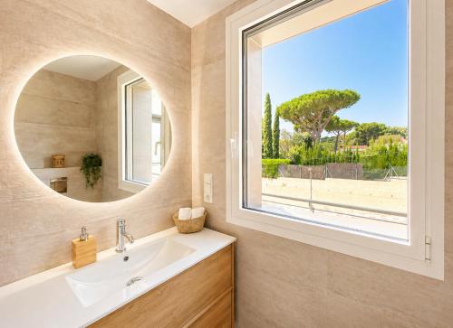 a bathroom with a sink and a large window at Naramia Sagaro Villa - with Pool-garden-10 Pax in S'agaro