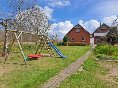 a playground with a slide and a frisbee at Ferienwohnung Morgenstern in Ausacker