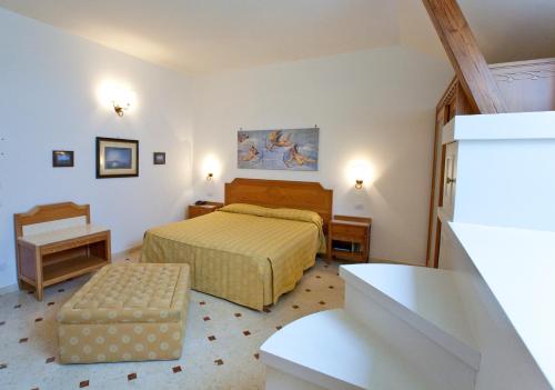 a small bedroom with a bed and a staircase at Villa Angelina in Massa Lubrense
