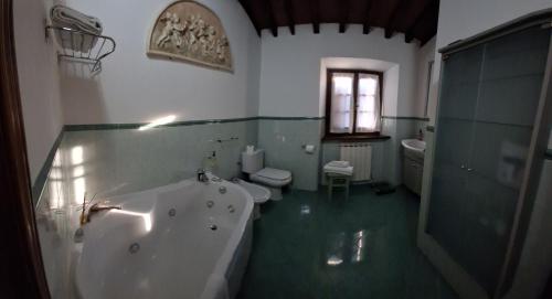 a bathroom with a tub and a toilet and a sink at B&B QUIConti in Agnino
