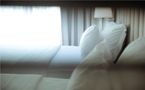 a bedroom with a bed with pillows and a window at Sugar Marina Hotel CLIFFHANGER Aonang in Ao Nang Beach