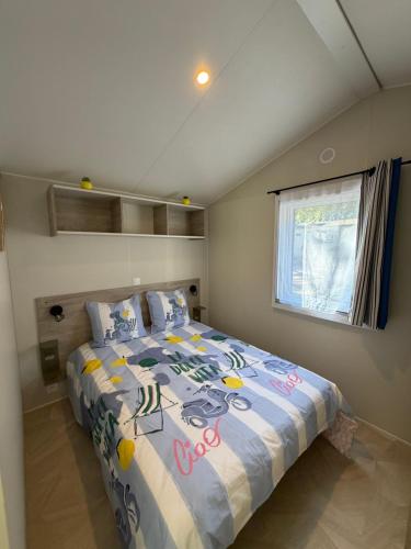 a bedroom with a bed and a window in it at Bahia in Le Faulq