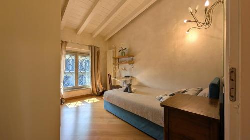 a bedroom with a bed and a window at La Corte Di Dafne in Bergamo