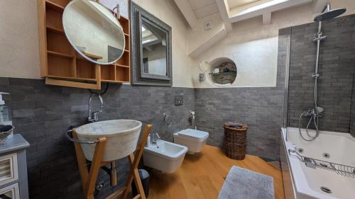 a bathroom with a sink and a toilet and a mirror at La Corte Di Dafne in Bergamo