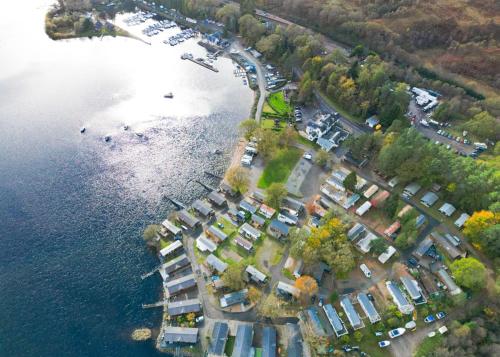 an aerial view of a group of houses by the water at Ardlui Holiday Park in Arrochar