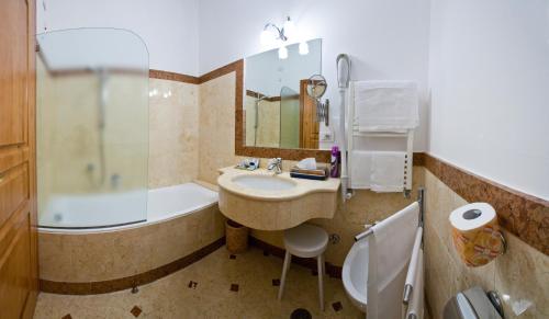 a bathroom with a sink and a shower and a tub at Villa Angelina in Massa Lubrense