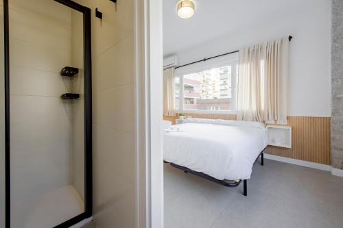 a bedroom with a white bed and a window at Plata by Clabao in Madrid