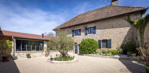 an exterior view of a stone house with a courtyard at Le Domaine Du Clos in Tourmont